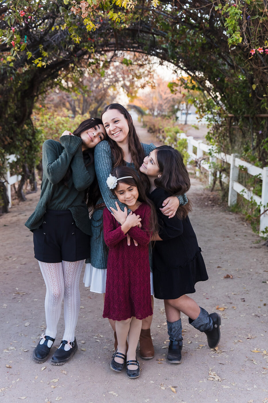 My family being silly under a beautiful arch of vines.
