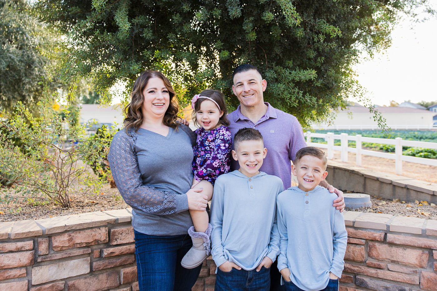 Family at Agritopia smiling at camera with two boys and a little girl.