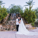 A beautiful wedding couple in from of the Colby Falls waterfall at sunset.