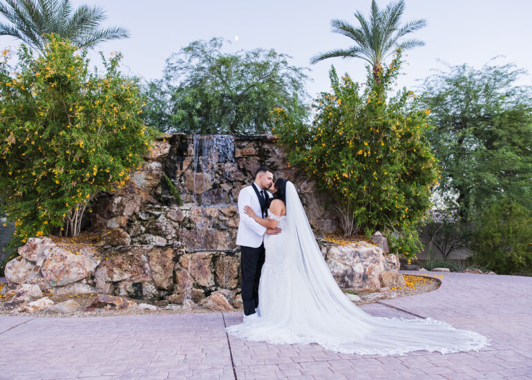 A beautiful wedding couple in from of the Colby Falls waterfall at sunset.