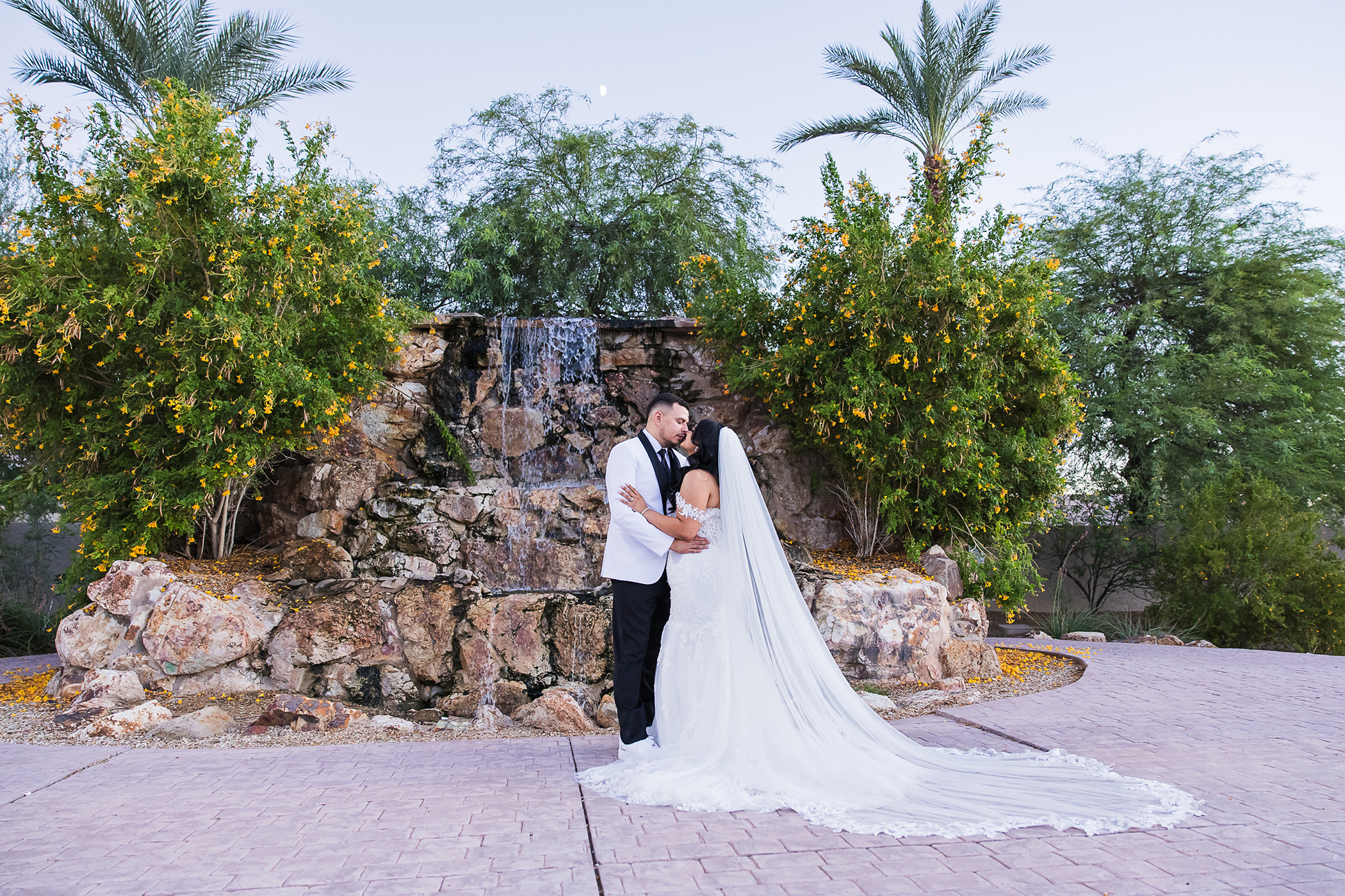 A beautiful wedding couple in from of the Colby Falls waterfall at sunset.