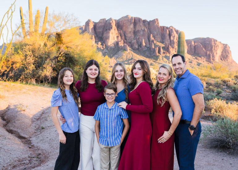 Family with 5 children in from of Superstition Mountain at sunset.